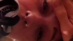 Pink labia close up of naive brunette playing with her name